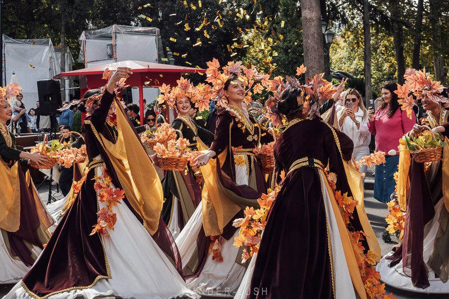 Women dressed in autumn regalia and leaf crowns perform in a street parade for the opening of the Tbilisoba festival in Tbilisi, Georgia.