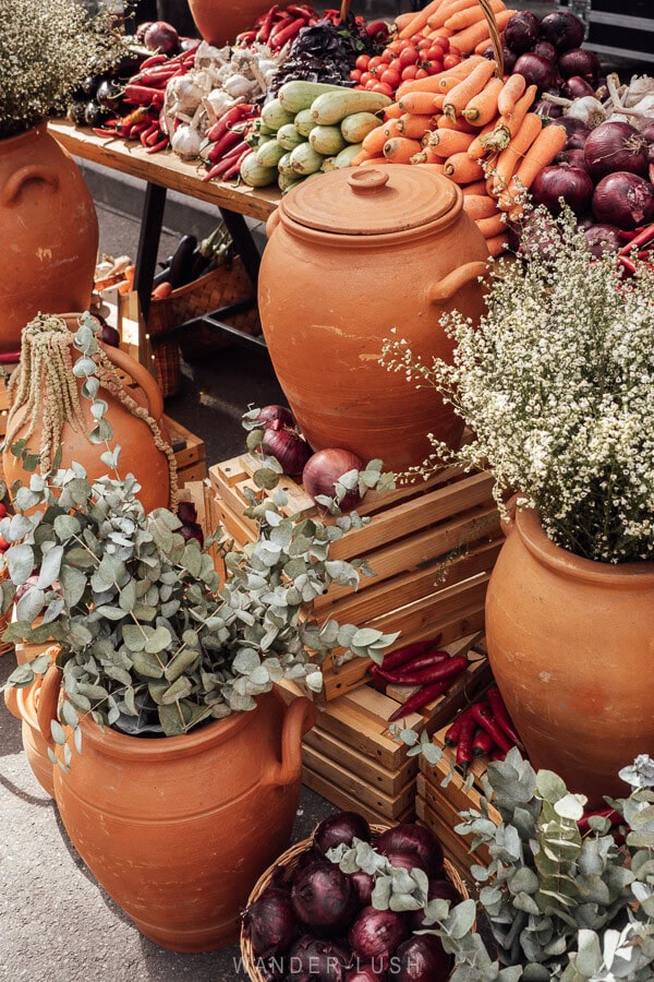 A display of produce and leaves in Georgian clay jars at the Tbilisoba festival.