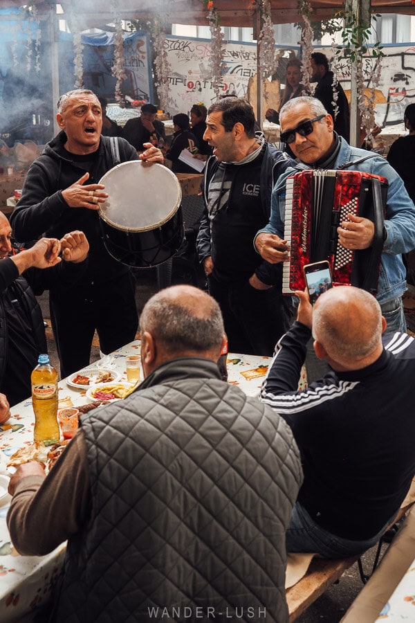A trio of musicians play for a table of diners at the Tbilisoba festival.