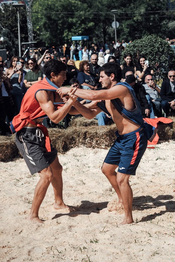 Two men wrestling in a Chidaoba match at the Tbilisoba festival in Tbilisi, Georgia.